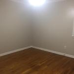 Main bedroom with no furniture and updated paint